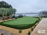 sloped backyard putting green next to boat dock